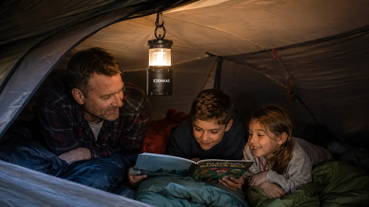 A second lantern glowing on low mode inside a tent, clipped near the ceiling loop
